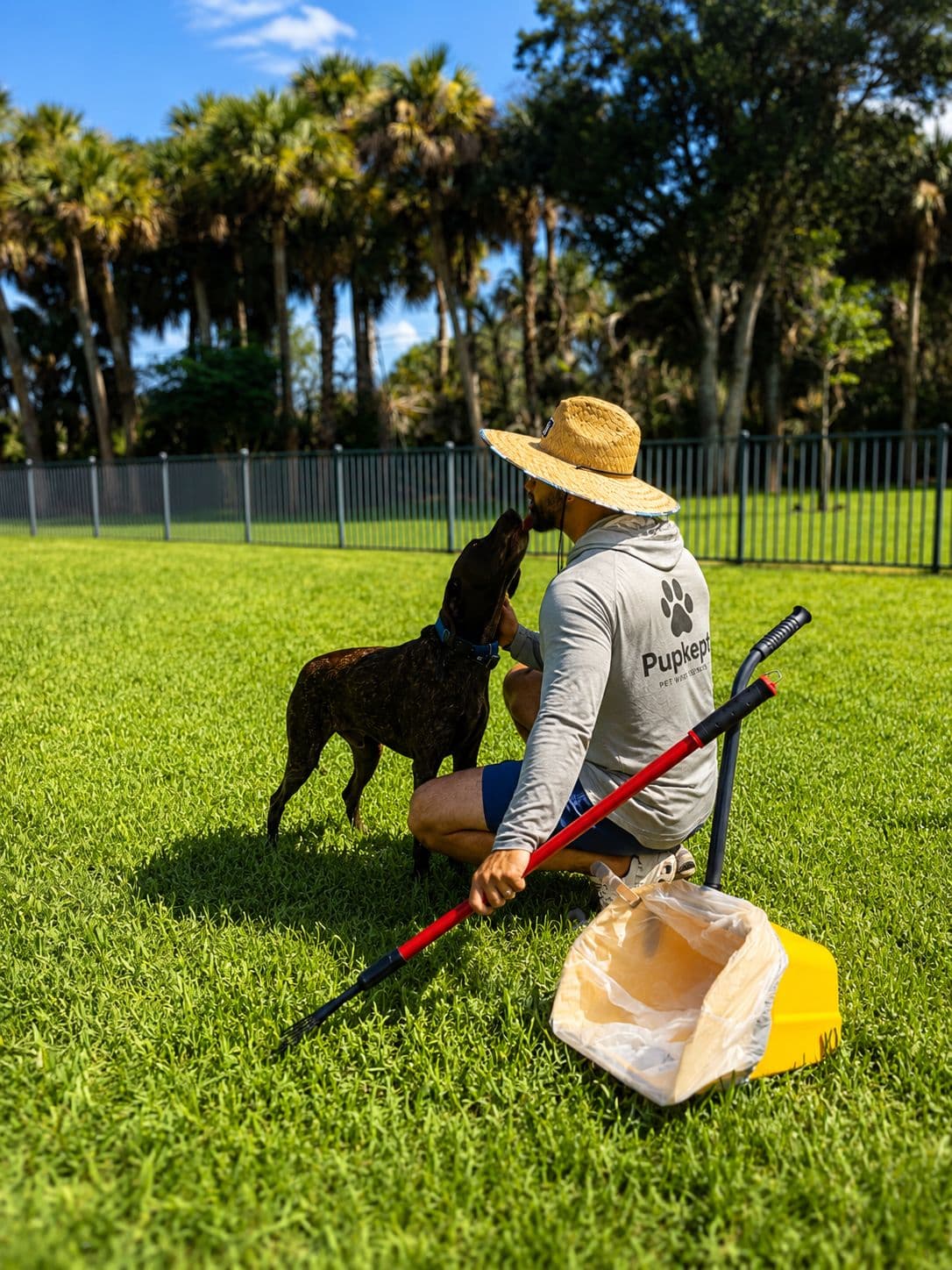 Pupkept owner sharing a moment with a dog after a yard cleanup
